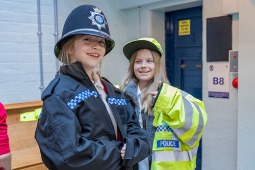 two youngsters loving wearing police uniform